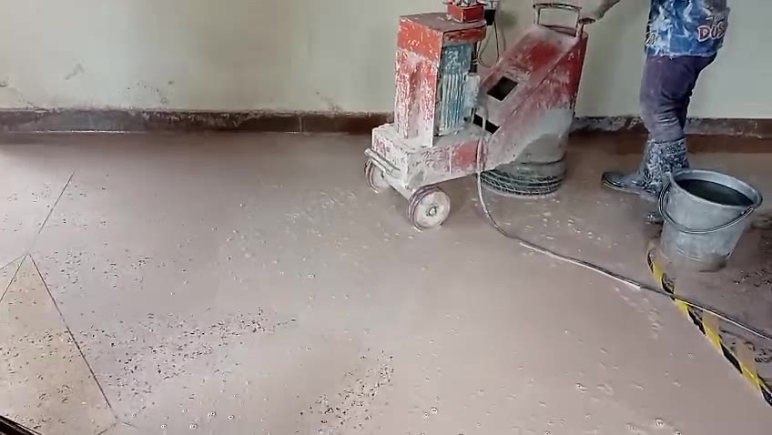Operator guiding the floor machine